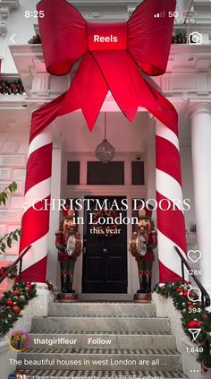 the front door of a building decorated for christmas with red and white striped bows on it