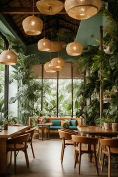 a restaurant with lots of plants hanging from the ceiling and wooden tables in front of them