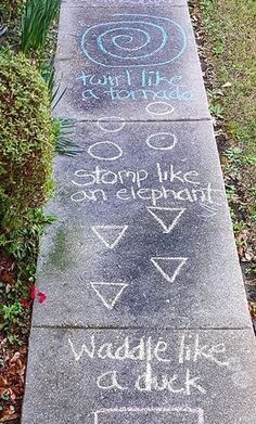 a sidewalk with chalk writing on it