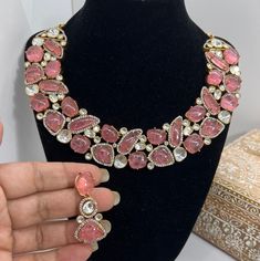 This Gorgeous Sabyasachi inspired with Moissanite Necklace with matching earrings. Comprises of Fine Oversized Uncut Kundan polki stones and Ruby color hangings This necklace is flexible and takes the shape of the neck. Fine quality and craftsmanship. Perfect for desi weddings. Necklace comes in drawstring cord therefore adjustable Earrings length: Approx 2.5 inches Festive Pink Jewelry With Stone Setting, Festive Pink Stone-set Jewelry, Pink Bollywood Choker For Festivals, Bollywood Style Pink Choker For Festivals, Heavy Choker Necklace For Party, Traditional Necklaces With Stones For Party, Traditional Party Necklaces With Stones, Heavy Pink Bridal Necklace For Party, Pink Choker For Party And Festivals