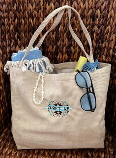 a purse with sunglasses and towels on it