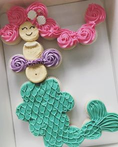 cupcakes in the shape of mermaid tailes with pink and purple icing