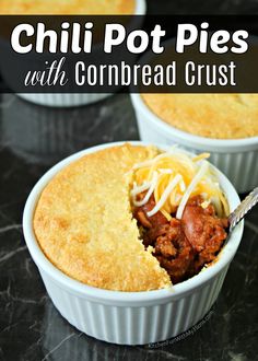 chili pot pies with cornbread crust in white dishes on a black countertop