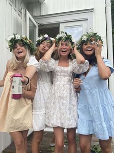 four women in dresses are posing for the camera