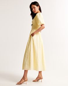 Step into the sunshine with the Abercrombie & Fitch Women's Tie-Front Textured Maxi Dress in a delightful pastel yellow. This dress combines elegance with comfort, making it a must-have for your wardrobe.

- **Size**: XS Petite
- **Color**: Pastel Yellow
- **Material**: Lining - Polyester, Elastane
- **Gender**: Female
- **Age Group**: Adult

This maxi dress features a flowy short-sleeve design crafted from soft textured seersucker fabric. The on-trend puff sleeves and plunging V-neckline add a Summer Maxi Length Puff Sleeve Dress For Daywear, Spring Maxi Length Puff Sleeve Dress For Day Out, Spring Midi Puff Sleeve Dress For Daywear, Spring Puff Sleeve Maxi Dress For Day Out, Chic Puff Sleeve Maxi Dress For Summer, Abercrombie Dress, Textured Maxi Dress, Female Features, Yellow Maxi Dress