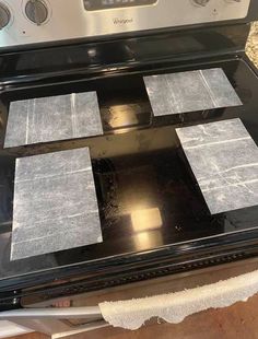 four pieces of paper are placed on top of an oven burner that has been sealed