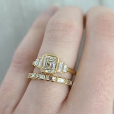 1.11ct M/SI2 GIA certified emerald cut diamond with 0.22ctw baguette cut accent diamonds bezel set in a handcrafted 18K yellow gold mounting. Gold Emerald-cut Lab Grown Diamond Wedding Sets, Rectangular Diamond Ring With Bezel Setting, Gold Asscher Cut Diamond Ring With Baguette Diamonds, Gold Emerald-cut Wedding Ring With Bezel Setting, Gold Emerald Cut Wedding Ring With Bezel Setting, Rectangular Baguette Diamond Wedding Ring, Asscher Cut Gold Diamond Ring With Baguette Diamonds, Gold Moissanite Diamond Ring With Baguette Diamonds, Gold Diamond Ring With Emerald Cut And Bezel Setting