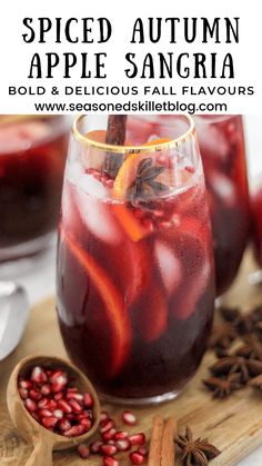 spiced autumn apple sangria in a glass with orange slices and pomegranate