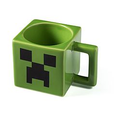 a green minecraft coffee mug sitting on top of a white table