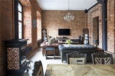 a living room filled with furniture and a flat screen tv mounted to the wall next to a fire place