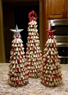 two wine cork christmas trees sitting on top of a counter