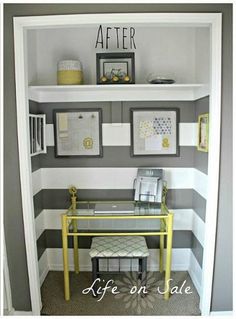 a small desk in the corner of a room with gray and white stripes on it