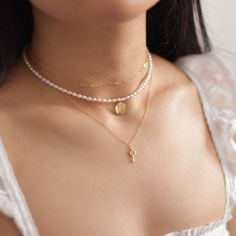 "A dainty pearl choker necklace with a single letter initial on a 14k gold filled round charm (can be customized to show 2 letters, rose, north star, or dandelion flower image instead by leaving a note at checkout). Round charm measures 10mm in diameter. Pearls are 2-3mm wide. Model is wearing the 14 inches. Made of 14K gold filled materials and genuine freshwater pearls, this choker necklace is tarnish-resistant, water-resistant, and hypoallergenic. --------------------♥ PROMOS ♥--------------- Dainty Pearl Chain Charm Necklace Choker, Dainty Pearl Chain Charm Necklace, Dainty Pearl Chain Choker Necklace, Pearl Chain Necklace With Initial Pendant, Dainty Pearl Charm Round Necklace, Dainty Pearl Pendant Necklace With Initial, Dainty Charm Necklaces With Pearl Initial Pendant, Dainty Charm Necklace With Pearl Chain And Round Pendant, Dainty Jewelry With Pearl Charm Initial Pendant