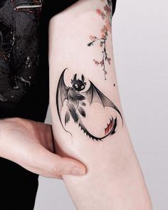 a woman with a bat tattoo on her arm