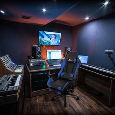 a recording studio with multiple monitors and keyboards