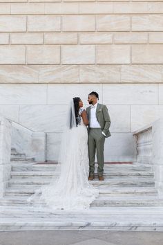 a bride and groom standing in front of the lincoln memorial