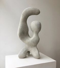 a white sculpture sitting on top of a white pedestal