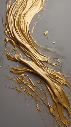 gold paint swirls on a gray surface