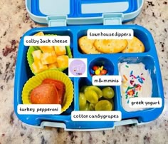 a blue lunch box filled with different types of food and words describing what to eat