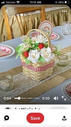 a table topped with a basket filled with flowers