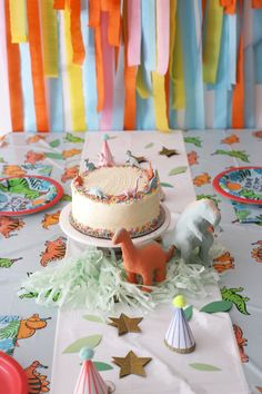 a birthday cake and party decorations on a table