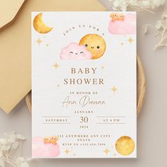 a baby shower is shown with pink clouds and yellow stars on the front, and an orange moon in the back