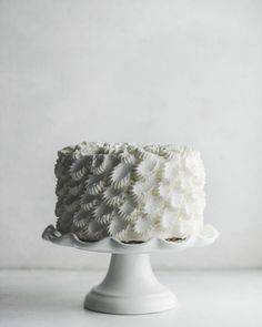 a white cake sitting on top of a white plate