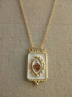 "You willl receive a beautiful Sacred Heart Pendant Necklace The scapuluar has enamel and is gold plated, the chain as well. Scapular meaures aprox 34mm x 22mm Necklace Length; 16\" inches 17\" 18\" 19\" 20\" 21\" 22\"" Gold Enamel Heart Necklace For Valentine's Day, Valentine's Day Gold Enamel Heart Necklace, Gold Enamel Heart Necklace For Gift, Scapular Necklace, Envelope Necklace, Heart Envelope, Catholic Necklace, Sacred Heart Of Jesus, Catholic Jewelry