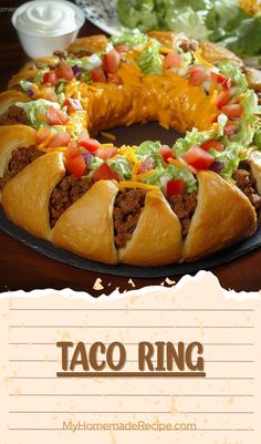 🌮 Taco Ring 🌮

Make dinner or party time fun and delicious with this easy Taco Ring! Seasoned beef and melty cheese are wrapped in flaky crescent rolls and baked to golden perfection. Serve with your favorite dips, like salsa, guacamole, or sour cream, for the ultimate shareable dish. Perfect for family dinners or gatherings, this Taco Ring is sure to be a crowd-pleaser! 
Taco Ring
Ingredients:
01 - 1 lb lean ground beef.
02 - 1 (1.25 oz) package taco seasoning mix.
03 - 1 cup shredded cheddar cheese (4 oz).
04 - 2 tbsp water.
05 - 2 (8 oz) packages refrigerated crescent dinner rolls.
06 - 1 medium bell pepper.
07 - 1 cup salsa.
08 - 3 cups shredded lettuce Crescent Dinner Rolls, Taco Ring, Crescent Roll Crust, Taco Seasoning Mix, Spicy Tacos, Salsa Guacamole, Seasoned Ground Beef, Baked Asparagus, Favorite Dips