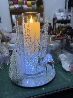 a glass candle holder with a horse on it