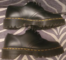 Dr. Martens Bex 21084 is a combat-style ankle boot with a lace-up closure and a round toe shape. The upper is made of black smooth leather, while the lining is made of leather and the insole is made of foam. The outsole is made of rubber and has a platform height of 1.5 inches. It has a flat heel style and a standard shoe width. This model is part of the Dr. Martens 1461 product line and is available in women's size 5 and men's size 4. THIS WAS STORE DISPLAY AND MIGHT HAVE BEEN TRIED ON...LOOKS BRAND NEW Doc Martens Platform Boots Mens, 1461 Smooth Leather Platform Shoes, Low Doc Martens, Dr Martens Bex, Doc Martens Black, Womens Booties, Combat Style, Low Shoes, Booties Ankle Boots