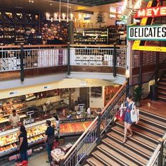 people are walking up and down the stairs in a grocery store