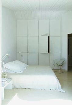 a bedroom with two beds and white walls