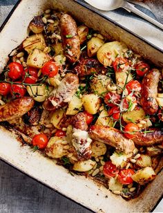 a pan filled with chicken, potatoes and tomatoes