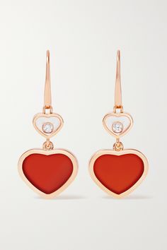 Chopard's 18-karat rose gold earrings are adorned with heart-shaped charms that symbolize love and good fortune - they're Co-President and Artistic Director Caroline Scheufele's favorite talisman. One is inlaid with vibrant red carnelian, while the other features a playful free-moving diamond encased in polished sapphire glass. Luxury Heart-shaped Drop Earrings For Valentine's Day, Luxury Earrings With Heart Charm, Luxury Double Heart Earrings For Valentine's Day, Luxury Double Heart Earrings, Luxury Heart-shaped Earrings For Gifts, Luxury Heart-shaped Earrings As Gift, Luxury Rose Gold Heart Earrings, Valentine's Day Polished Finish Earrings, Luxury Yellow Gold Heart Earrings As Gift