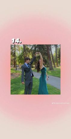 a man and woman are dancing in the grass with their hands up to each other