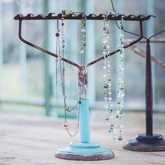 a hanukkah with beads and chains hanging from it's sides on a wooden table