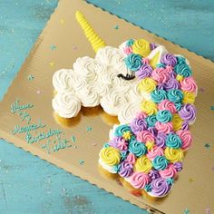 a cupcake shaped like a unicorn on top of a cardboard box