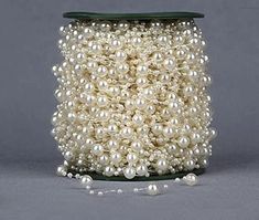 a spool of white pearls on a gray background