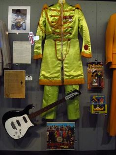 an elvis presley outfit and guitar are on display