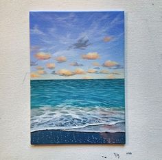 an acrylic painting of the ocean with clouds in the sky and blue water