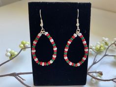 These simple green, red and white glass seed bead and wire teardrop dangle earrings will put you in a festive spirit. Made with silver-plated non-nickel ear wires and comes with a silicone backers.  This item will come packaged in a gift box. I'm happy to include a message for the recipient.   All items are designed and handmade to order by me.  Requests for customizations are welcomed. I will do my best to have your order in the mail within 24 hours. Thank you for supporting my small business! Dangle Teardrop Earrings With Tiny Beads As Gift, Gift Teardrop Dangle Earrings With Tiny Beads, Teardrop Dangle Earrings, Simple Green, Earring Patterns, Seed Bead Earrings, Beads And Wire, Bead Earrings, I'm Happy