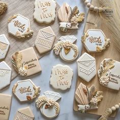 decorated cookies are arranged on a table with gold trimmings and words that spell out their names