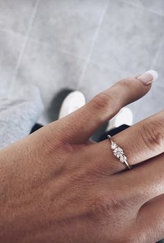 a woman's hand with a diamond ring on top of her finger and the text,