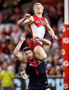 two men compete in a high jump during a sporting event