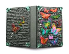 an open book with colorful butterflies on it