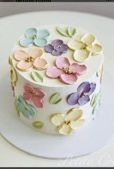 a white cake with colorful flowers on it