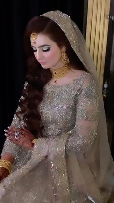 a woman with long hair wearing a wedding dress