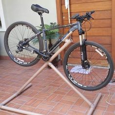 a bicycle on a stand in front of a door