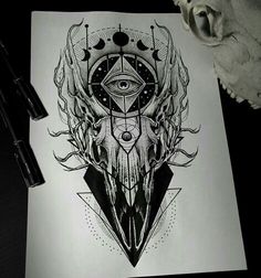 a black and white drawing of an all seeing eye on paper next to a pen